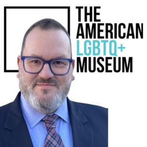 Ben Garcia in front of The LGBTQ plus museum logo