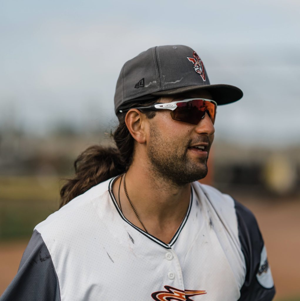 Bryan Ruby wearing sunglasses and dressed in a baseball uniform