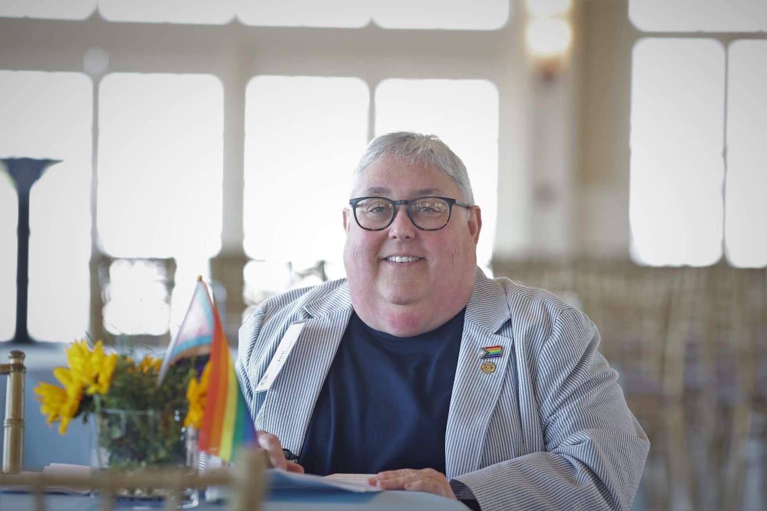 Deb Guston holding a pride flag