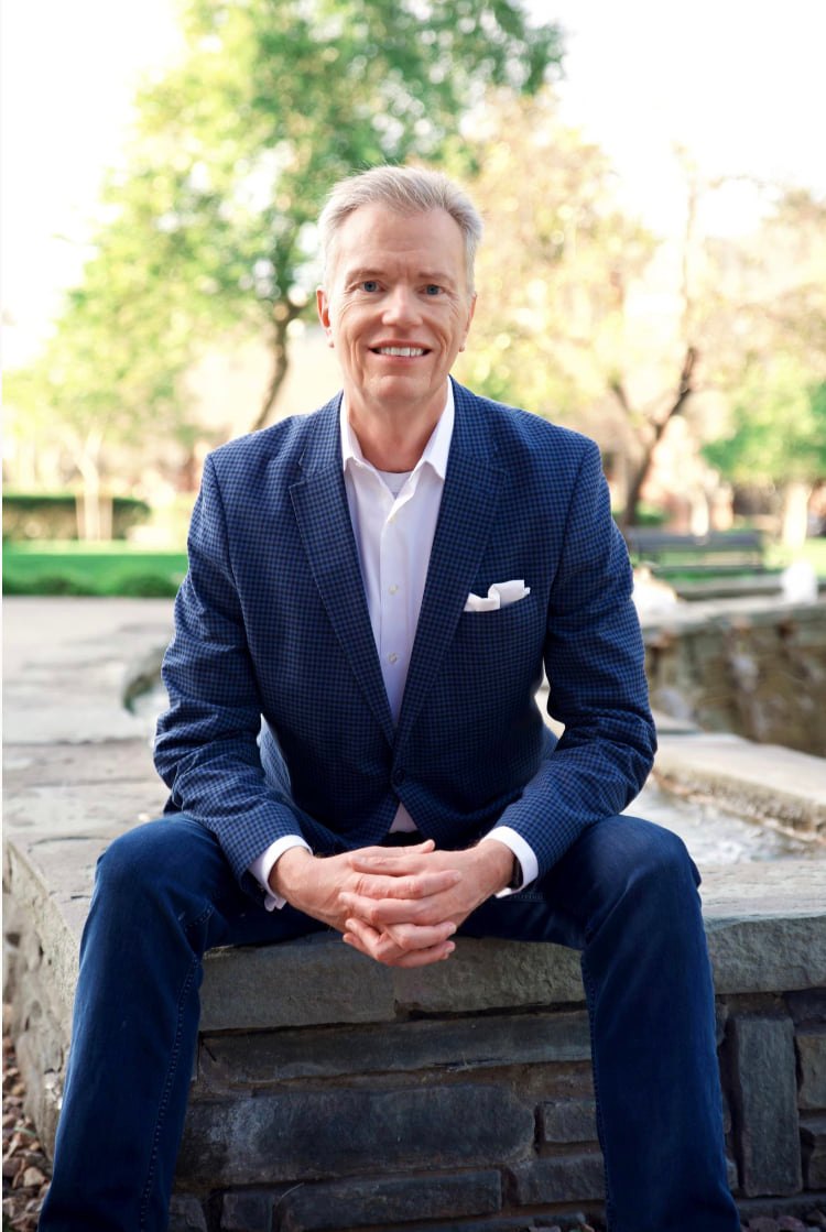 David S Pederson seated while wearing a suit.