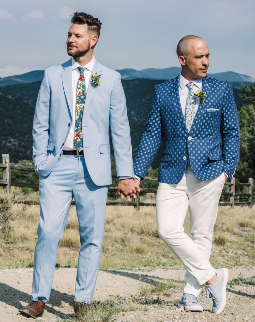 David and John holding hands outside in the mountains